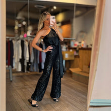 Load image into Gallery viewer, Model wearing Aurora Boutique Miami Alejandria one-shoulder black sequin jumpsuit in a boutique mirror selfie