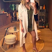 Load image into Gallery viewer, Aurora Boutique Miami beige linen high-low button-up cover up with collar and mock pockets worn by a model