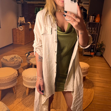 Load image into Gallery viewer, Aurora Boutique Miami beige linen high-low cover up with button front, collar, and mock pockets worn by a model