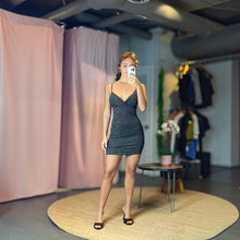 Load image into Gallery viewer, Model wearing a black Aurora Boutique Miami Omaha Lurex mini dress with spaghetti straps in a boutique setting