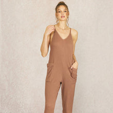 Load image into Gallery viewer, Model wearing a brown Aurora Boutique Miami Lotus cable knit jumpsuit with spaghetti straps and side pockets