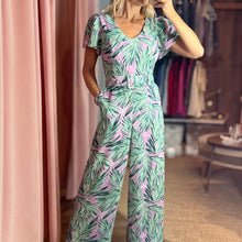 Load image into Gallery viewer, Aurora Boutique Miami Cite floral jumpsuit with green palm leaf print on a lavender background and belted waist