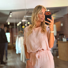 Load image into Gallery viewer, Aurora Boutique Miami Delmar linen blouse in soft pink worn by a blonde model taking a mirror selfie in a boutique