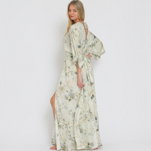Load image into Gallery viewer, Model wearing Aurora Boutique Miami Saravena floral maxi dress with kimono sleeves and tie back detail