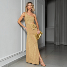 Load image into Gallery viewer, Aurora Boutique Miami model wearing a gold lurex one-shoulder crochet maxi dress with a side cutout and waist bow.