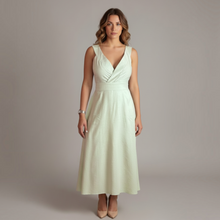 Load image into Gallery viewer, Model wearing Aurora Boutique Miami Kara Minty tied maxi dress in light green with a V-neckline and fitted waist