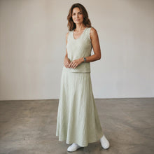 Load image into Gallery viewer, Model wearing Aurora Boutique Miami sage green linen sleeveless top and matching maxi skirt in a studio setting.
