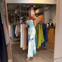 Load image into Gallery viewer, Aurora Boutique Miami Caceres strapless maxi dress in white with blue floral print and back chest tie detail