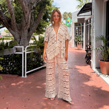 Load image into Gallery viewer, Model wearing Aurora Boutique Miami Nicole 3-piece beige crochet set with open-front top and wide-leg trousers
