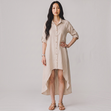 Load image into Gallery viewer, Aurora Boutique Miami beige linen high-low cover up with collar and button-front worn by a model
