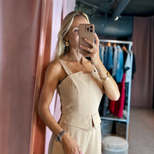 Load image into Gallery viewer, Model wearing a beige Aurora Boutique Miami Lucy viscose jumpsuit with a square neckline in a boutique setting
