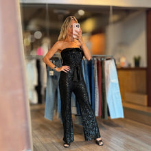 Load image into Gallery viewer, Aurora Boutique Miami Alegria black sequin tube jumpsuit with a waist belt worn by a model in a clothing store
