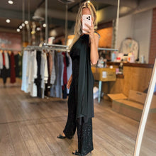 Load image into Gallery viewer, Aurora Boutique Miami Alejandria one-shoulder black sequin jumpsuit worn by a model in a boutique setting
