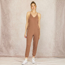 Load image into Gallery viewer, Model wearing Aurora Boutique Miami brown cable knit jumpsuit with spaghetti straps and side pockets
