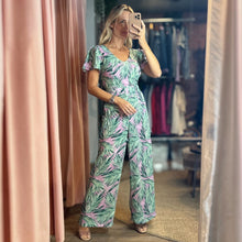 Load image into Gallery viewer, Aurora Boutique Miami Cite floral jumpsuit with flutter sleeves and wide legs worn by a model in a mirror selfie
