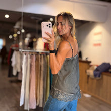 Load image into Gallery viewer, Aurora Boutique Miami Felisa satin camisole top in olive green with delicate lace hem, worn by a blonde model.
