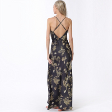 Load image into Gallery viewer, Aurora Boutique Miami Candelaria maxi dress featuring a black and gold floral print, cowl back, and crisscross straps.
