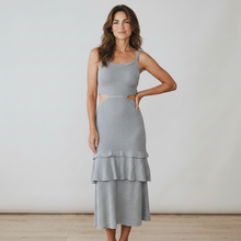 Load image into Gallery viewer, Model wearing a grey Aurora Boutique Miami Paulina lurex crochet midi dress with side cutouts and tiered ruffle skirt
