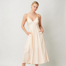 Load image into Gallery viewer, Aurora Boutique Miami Ivetta midi dress with thin straps, v-neck, and vertical stripes on a model with pockets
