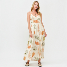 Load image into Gallery viewer, Aurora Boutique Miami Juniper open back maxi dress in cream with orange and green seashell print on a model
