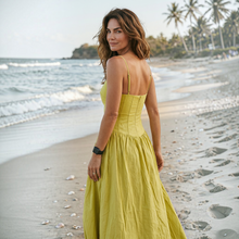 Load image into Gallery viewer, Model wearing an Aurora Boutique Miami lime green linen cotton midi dress with spaghetti straps on a sandy beach
