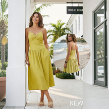 Load image into Gallery viewer, Model wearing an Aurora Boutique Miami lime green linen cotton midi dress with a sweetheart neckline and pockets.

