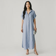 Load image into Gallery viewer, Model wearing a light blue Aurora Boutique Miami Naomi linen shirt dress with button front and side slits
