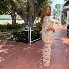 Load image into Gallery viewer, Aurora Boutique Miami Nicole crochet three-piece set in beige worn by a woman standing on a sidewalk

