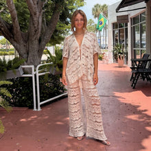 Load image into Gallery viewer, Aurora Boutique Miami Nicole crochet three-piece set in beige worn by a woman on a sunny outdoor patio
