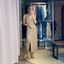 Load image into Gallery viewer, Woman wearing a nude knit midi dress with a side slit and textured pattern from Aurora Boutique Miami
