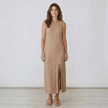 Load image into Gallery viewer, Model wearing an Aurora Boutique Miami nude sleeveless knit midi dress with a side slit and textured cable pattern
