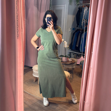 Load image into Gallery viewer, Woman wearing an Aurora Boutique Miami olive green cotton t-shirt dress with a side slit in a mirror selfie
