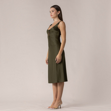 Load image into Gallery viewer, Model wearing an olive green Aurora Boutique Miami Terese satin midi dress with a lace-up front detail
