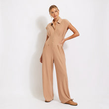 Load image into Gallery viewer, Model wearing Aurora Boutique Miami Idra ribbed beige jumpsuit with a button-down collar and wide-leg silhouette.
