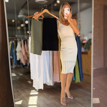Load image into Gallery viewer, Aurora Boutique Miami model wearing a cream ribbed knit midi dress with openwork details, holding olive and black options

