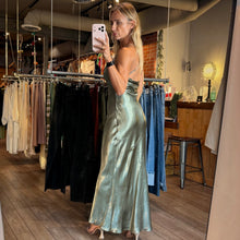 Load image into Gallery viewer, Aurora Boutique Miami Zaria woven silk maxi dress in sage green worn by a model in a mirror selfie
