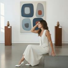 Load image into Gallery viewer, Model wearing Aurora Boutique Miami white Suzanne Skirt Set in an art gallery, featuring a sleeveless vest and skirt.
